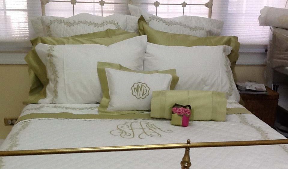 Green and white pillows and sheets on bed